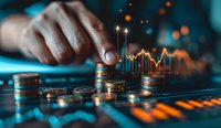 Financial data visualization with stacked coins and glowing market charts, male hand arranging currency on dark surface with orange and blue lighting effects.