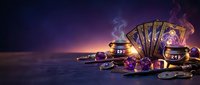 Tarot cards spread with glowing crystals and mystical purple lighting on dark surface for divination and spiritual guidance purposes.