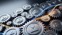 Metallic gears and cogs mechanism with golden light streak representing industrial automation, engineering precision and mechanical innovation concepts.