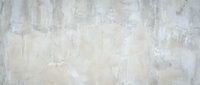 Weathered concrete wall with cream and gray tones, featuring natural texture and aged paint for industrial, grunge, or minimalist design projects.