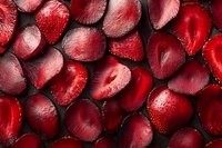 Fresh sliced strawberries background with vibrant red color and juicy texture, arranged in a flat lay pattern for food photography and culinary designs.