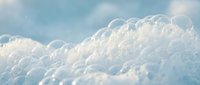 Dreamy white fluffy clouds floating in soft blue sky creating peaceful heavenly atmosphere for meditation and relaxation backgrounds.