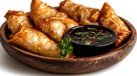 Golden crispy spring rolls served in wooden bowl with dark dipping sauce and fresh herbs garnish on white background isolated for restaurant menu design.
