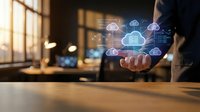 Businessman holding glowing cloud computing network icons above hand in modern office, digital data storage and technology concept.