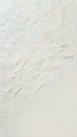 Close-up of white marble stone surface with natural veining and texture, suitable for backgrounds, interior design projects, and architectural materials.