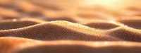 Golden sand dunes with tiny water droplets glistening in warm sunlight, creating a serene desert landscape at sunset.