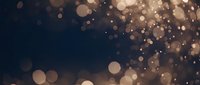 Abstract golden bokeh lights on dark background creating magical atmosphere for luxury events and celebrations.