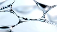 Macro photography of soap bubbles or liquid surface tension creating abstract geometric patterns in light blue and white tones, showing delicate membrane structures.