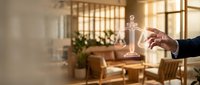 Lawyer holding glowing scales of justice hologram in modern office with wooden furniture and natural light, symbolizing legal services, law practice, and professional consultation.