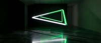 Futuristic neon triangle glowing in dark concrete room with reflective floor creating modern sci-fi atmosphere for digital art and gaming backgrounds.