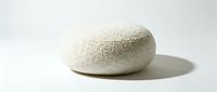 Round cream boucle fabric ottoman pouf on white background, modern minimalist furniture piece with soft textured upholstery for interior design.