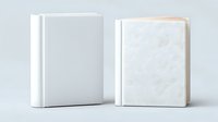 White hardcover books standing upright on light background, blank template mockup for branding and publishing design projects, isolated with clean edges.