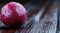 Fresh red cherry with water droplets on dark wooden surface in macro photography, highlighting natural texture and freshness for food and beverage marketing.