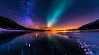 Stunning aurora borealis dancing over frozen lake with starry night sky and mountain silhouettes creating magical winter landscape reflection on ice surface.