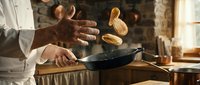 Professional chef tossing mushrooms in cast iron skillet during cooking process in rustic kitchen environment for culinary preparation.