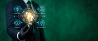 Businessman holding glowing lightbulb with innovation icons on green background representing creative business solutions and technological advancement.