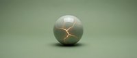 Cracked sphere with golden fracture lines on matte sage green surface, isolated on matching background for design and creative projects.