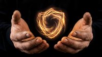 Hands cupping glowing energy spiral with golden light trails creating magical fire effect on dark background for spiritual and mystical concepts.