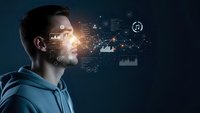 Young Caucasian man in hoodie looking at futuristic holographic data visualization with charts, graphs and digital interface elements on dark background.
