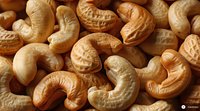 Roasted cashew nuts macro shot showing detailed texture and natural golden color pattern, healthy organic snack food background for packaging design.