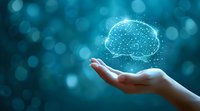 Glowing digital brain hologram floating above open palm against turquoise bokeh background, representing artificial intelligence and future technology concept for business innovation.