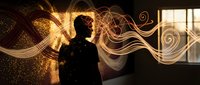 Young professional man silhouette with flowing golden light waves and sparkles in modern office space for creative business and innovation concepts.