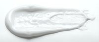 Creamy white cosmetic product smear or skincare lotion texture isolated on white background, ready for beauty and wellness design applications.