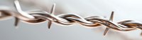 Twisted copper and silver electrical wires macro close up on light background showing industrial technology and power connection details.