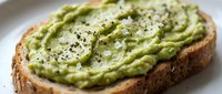 Fresh avocado toast on artisan bread topped with sea salt and black pepper, healthy breakfast or snack option for nutritious eating and wellness lifestyle.