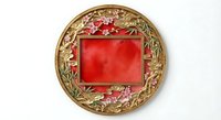 Ornate golden frame with red velvet center and floral decorations isolated on white background for luxury design projects and elegant presentations.