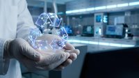 Young male professional in white lab coat holding glowing digital cube network structure in palm, representing data technology, innovation, and scientific research in modern laboratory environment.