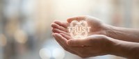 Hands holding glowing house symbol representing home ownership, real estate investment, property protection, and housing security concepts for business and financial design.