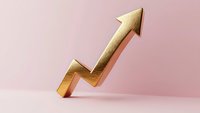 Golden upward trending arrow on pink background showing growth, success and positive financial performance. Minimal business concept with soft shadows.