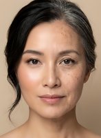 Mature Asian woman with natural aging skin showing wrinkles and age spots in skincare and beauty portrait for anti-aging cosmetics and wellness campaigns.