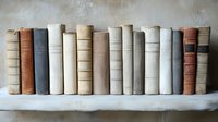 Row of vintage hardcover books in neutral earth tones standing on white wooden shelf against textured wall, creating minimalist literary atmosphere.