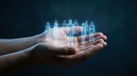 Human hands holding glowing holographic people figures representing team management, leadership and business networking concepts for corporate presentations.
