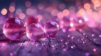Transparent glass spheres on glittery surface with pink and purple bokeh lights creating magical atmosphere. Macro photography with shallow depth of field.