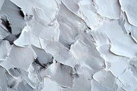 White textured abstract background with rough plaster strokes and uneven surface creating dynamic light and shadow pattern. Artistic wall decoration.