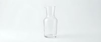 Empty clear glass bottle with narrow neck isolated on white background, suitable for beverage packaging design and product mockups.