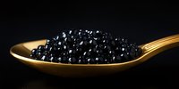 Black caviar on golden spoon against dark background, luxury gourmet food close-up with selective focus highlighting premium sturgeon roe delicacy.