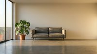 Modern living room interior with gray leather sofa, potted plant, and large window overlooking cityscape. Minimalist design with polished concrete flooring.