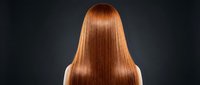 Long straight copper red hair from behind on dark background showcasing glossy healthy strands for beauty salon haircare and styling concepts.