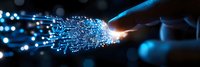 Glowing optical fiber cable connection with light trails and bokeh effect against dark background, symbolizing high-speed data transmission and internet connectivity.
