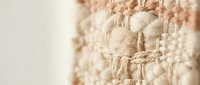 Close-up of natural jute twine and cotton rope texture with neutral beige tones, suitable for craft, packaging, and rustic design projects.