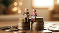 Miniature elderly couple figurines sitting on stacks of coins representing retirement planning and financial security for senior citizens.