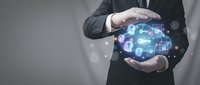 Businessman in dark suit holding glowing digital network globe with interconnected icons, representing global connectivity, data security, and technology infrastructure for business solutions.