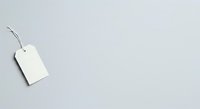 Blank white price tag with string on gray background, isolated and ready for design use on product packaging, retail displays, and branding projects.