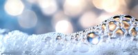 Macro shot of soap bubbles with bokeh light effects creating dreamy atmosphere. Soft blue and white tones with delicate foam structure and reflective spheres.