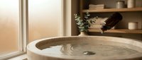 Modern bathroom sink with running water faucet in warm natural lighting. Contemporary home interior design with wooden shelving and minimalist decor.