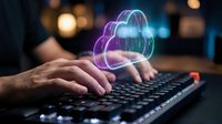 Hands typing on keyboard with glowing cloud computing hologram for data storage, cybersecurity and digital transformation in modern office environment.